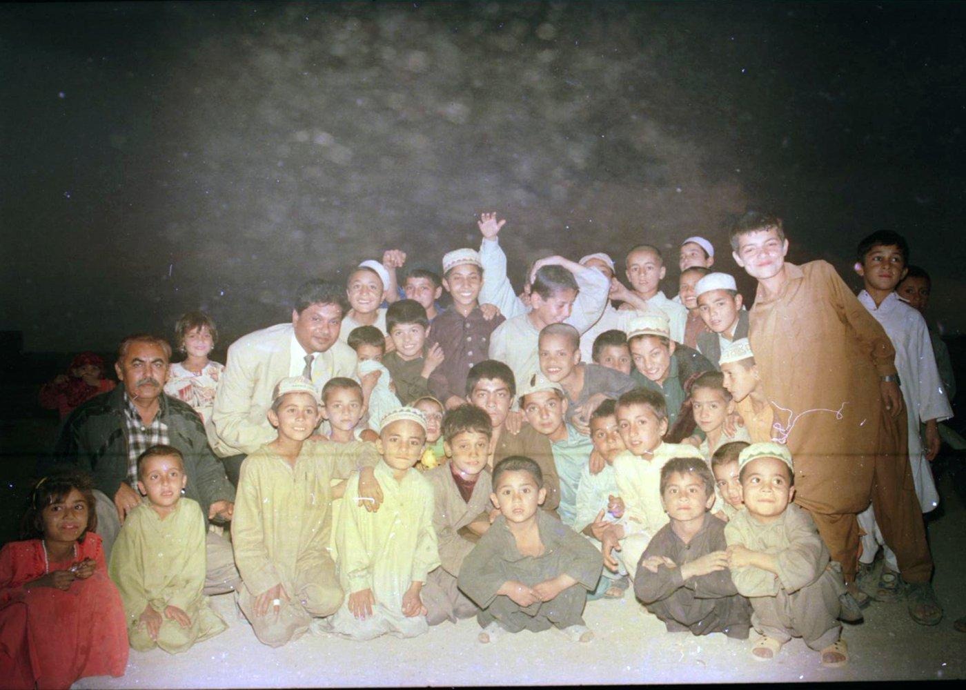 A group portrait with dozens of children, taken at the end of an evening visit. A group portrait with dozens of children, taken at the end of an evening visit.