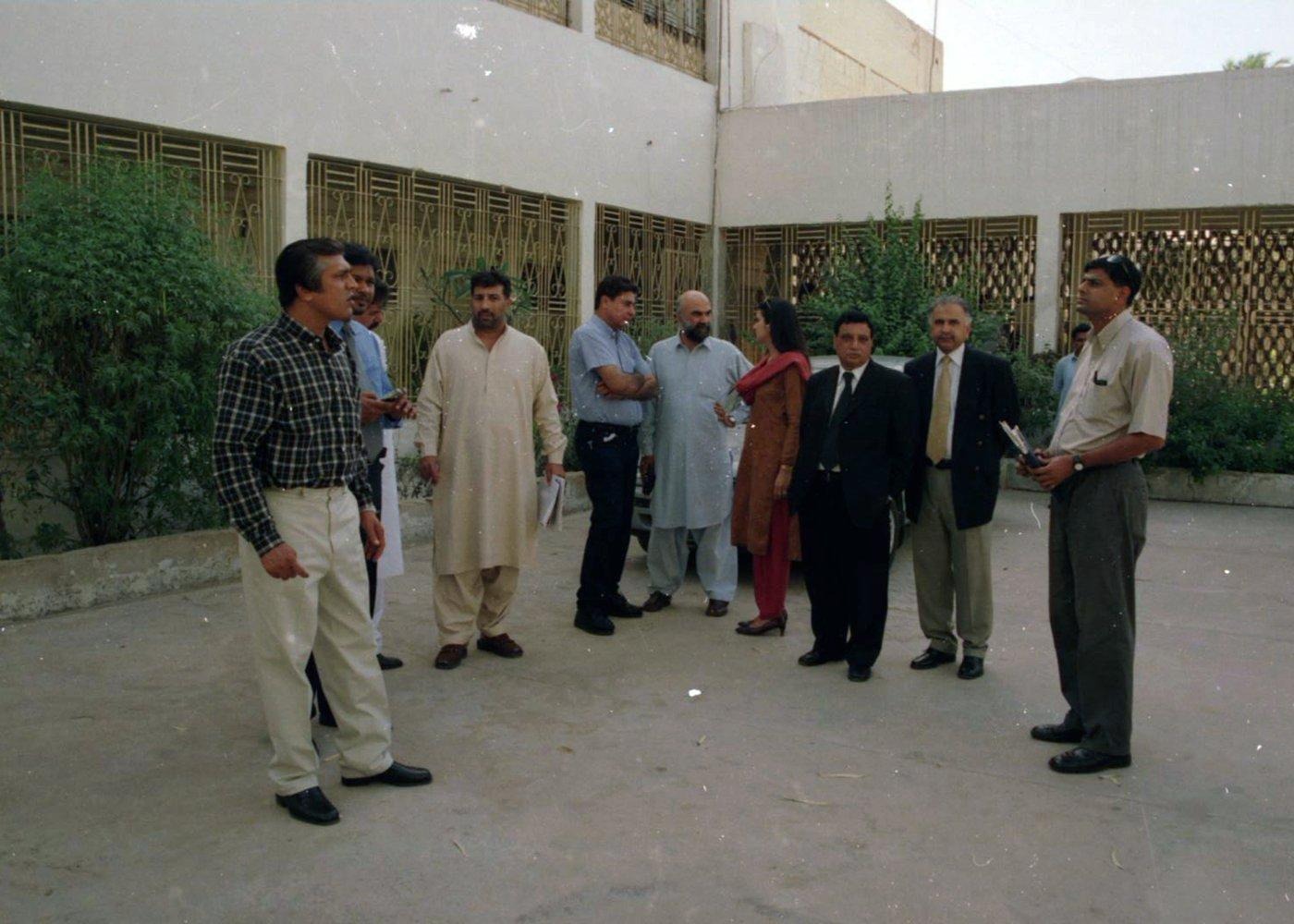Team gathering in a courtyard Before the visit begins: team members and partners gather in the courtyard of a facility to plan the day.