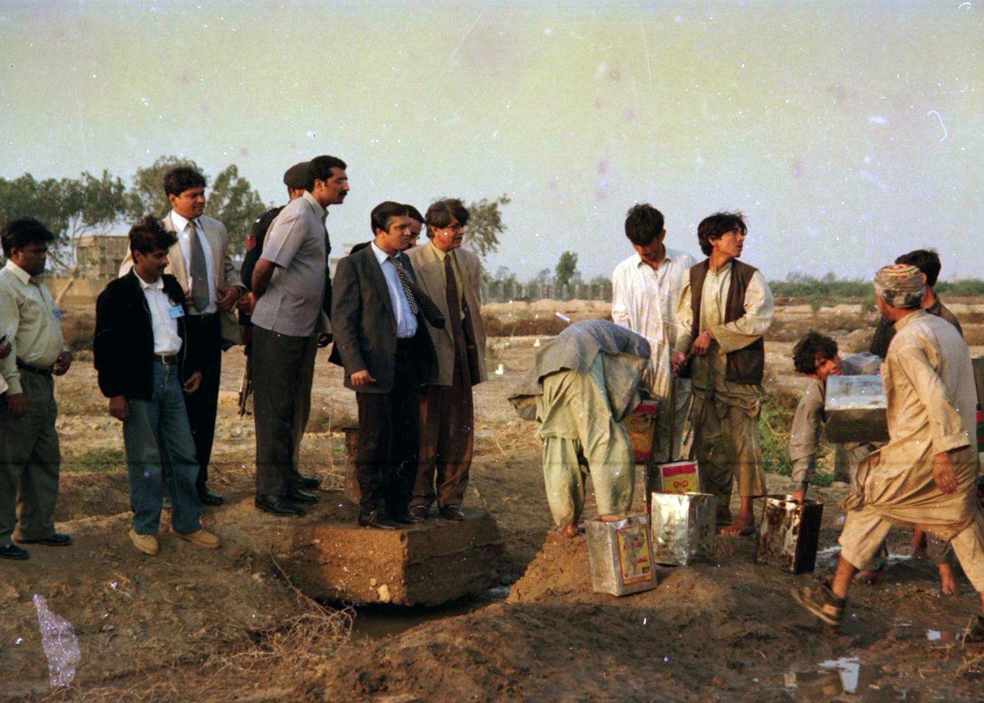 Members of the ICOHR delegation observe the water point at first hand, accompanied by security personnel and local helpers. Members of the ICOHR delegation observe the water point at first hand, accompanied by security personnel and local helpers.