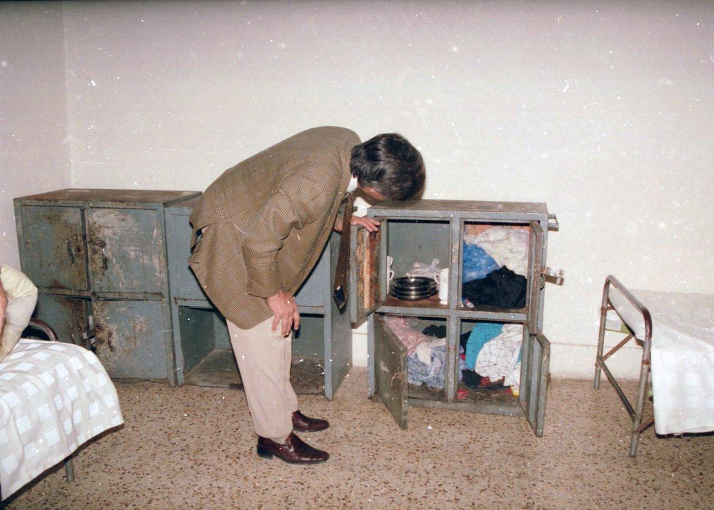 Inspecting steel lockers Checking what a resident actually owns: a team member inspects the steel lockers where plates, mugs and clothes are stored.