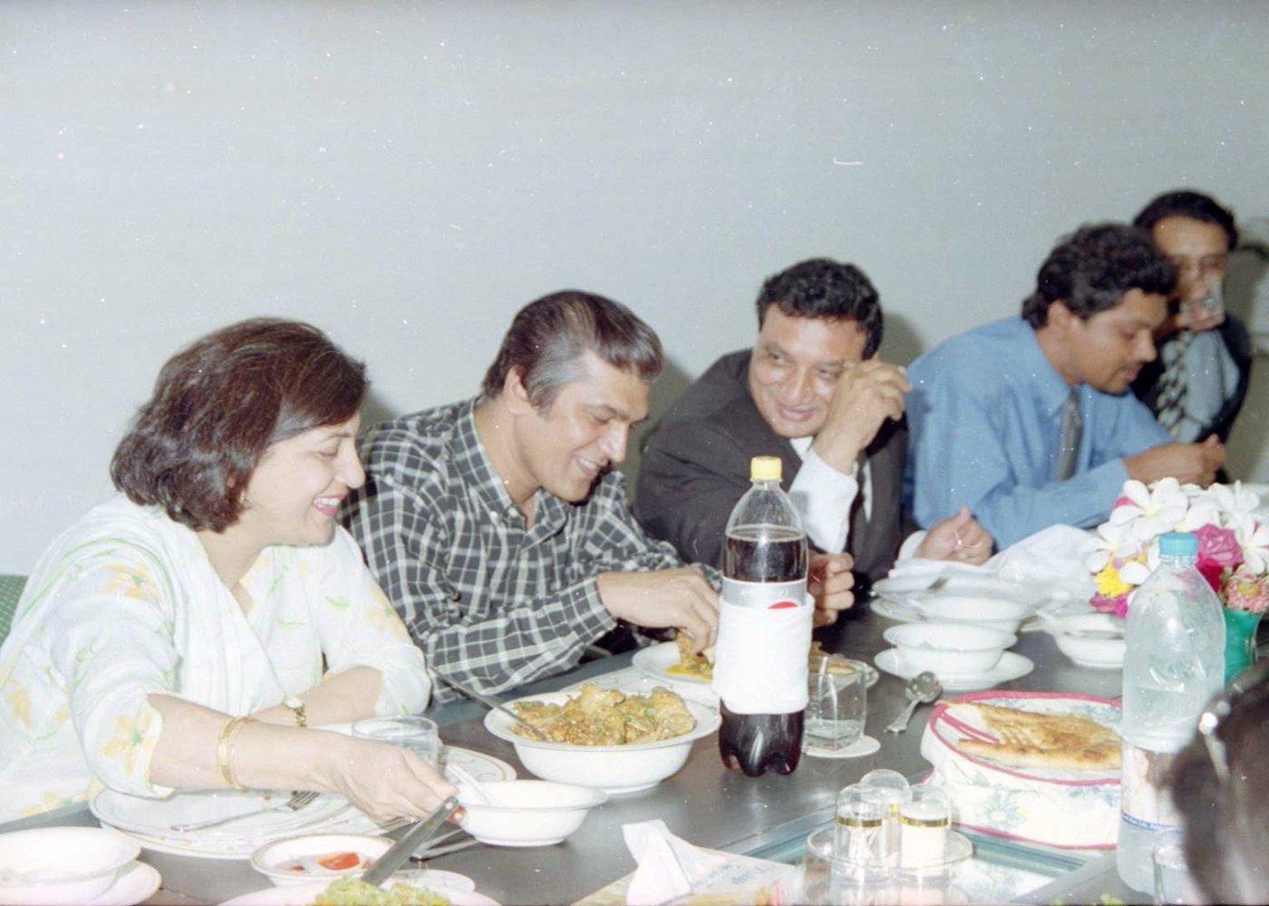 Team members sharing a meal Field work also runs on conversation: team members and partners share a meal and compare notes.